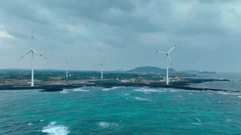 Aerial view of Sinchang Windmill Coast in Jeju Island, Wind turbine Stock Footage 296499320