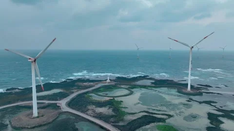 Aerial view of Sinchang Windmill Coast in Jeju Island, Wind turbine Stock Footage 296502683