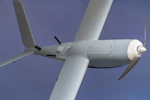 Aerial view of a single-engine propeller plane against cloudy sky, emphasiz.. Photos