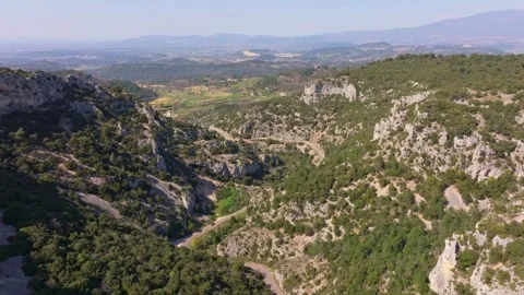 Aerial view of single red car navigating mountain curves near Venasque Stock Footage 313162097