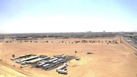 Aerial view of a site cabin compound beside open sandy ground 库存影片 346428592