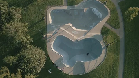 Aerial view of skateboarders doing tricks in the skate park. Stock Footage 247460171