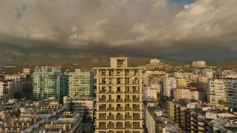 Aerial View: The skeleton of a high-rise building stands tall on the beachfront Stock Footage 296078326