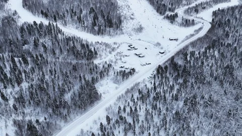 Aerial view of ski resort and snowy forest mountain road, Norway 動画素材 340038084
