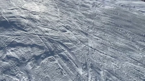 Aerial view of a ski slope with a light blizzard moving powder snow upwards Stock Footage 202250728