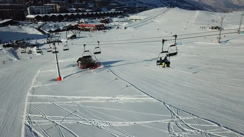 Aerial view of skiers climb the ski lift up in Piedmont/Sestriere, Italy Stock Footage