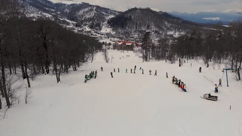 Aerial view of a skiing instructor with students at a ski school. Stock Footage 122263817