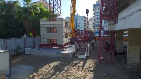 Aerial View: Skilled crane operator works confidently, assembling components and Vídeo Stock 296023112