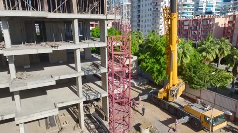 Aerial View: Skilled operator assembles components, climbing ladders confidently Vídeo Stock 296021474