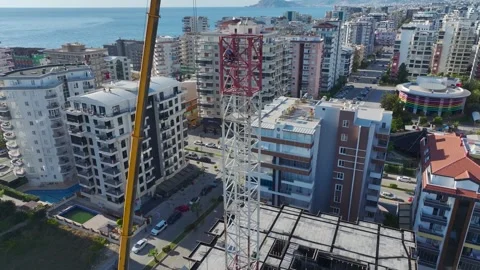 Aerial View: Skilled operator mounts crane parts and scales ladders with Vídeo Stock 296022800