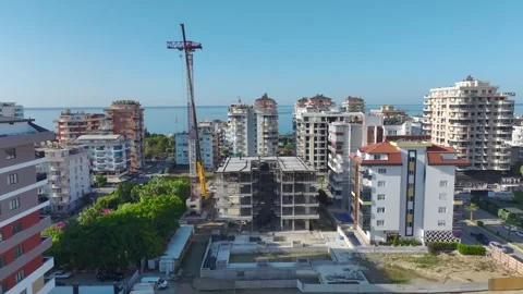 Aerial View: Skilled operator mounts large crane parts while climbing ladders Vídeo Stock 296025482