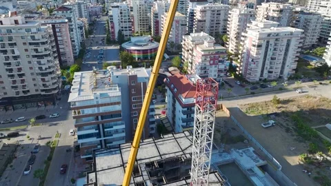 Aerial View: Skilled operator navigates ladders and assembles parts of a massive Vídeo Stock 296023797