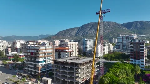 Aerial View: Skilled operator navigates ladders effortlessly, assembling crane Vídeo Stock 296025572
