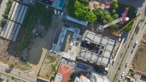 Aerial View: Skilled operator navigates ladders carefully, assembling crane Vídeo Stock 296025877