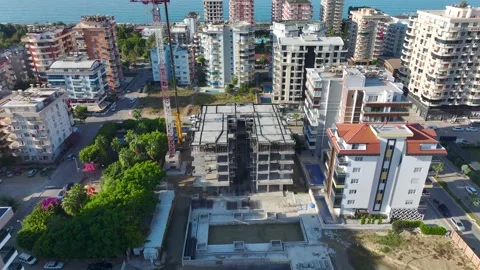Aerial View: Skilled operator works on a massive crane, climbing ladders with Vídeo Stock 296025030