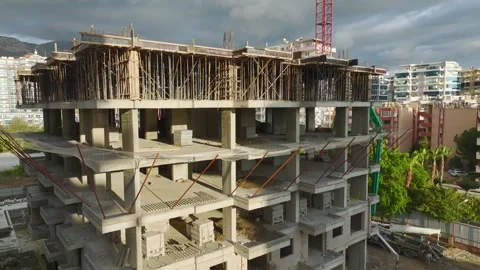 Aerial View: A skilled worker shapes the fresh concrete on a stair landing Stock Footage 296075518