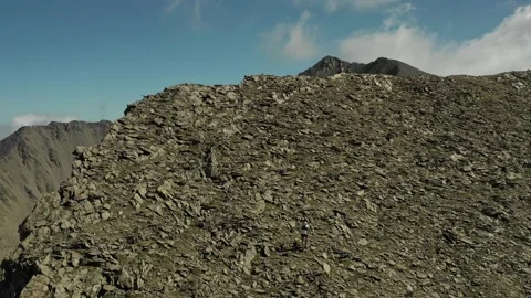 Aerial view of sky-runner running high in the mountains. Stock Footage 138577253