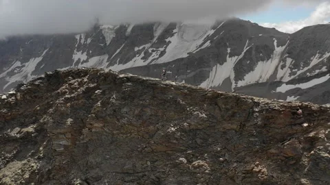 Aerial view of sky-runner running high in the mountains. Stock Footage 138577403