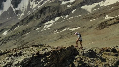 Aerial view of sky-runner running high in the mountains. Video stock 138577890