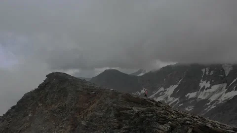 Aerial view of sky-runner running high in the mountains. Stock Footage 138579173