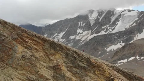 Aerial view of sky-runner running high in the mountains. Stock Footage 138579618