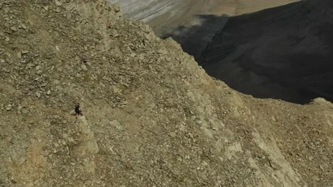 Aerial view of sky-runner running high in the mountains. Stock Footage 138579755