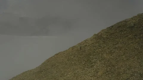 Aerial view of sky-runner running high in the mountains. Stock Footage 140973300