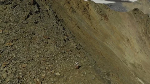 Aerial view of sky-runner running high in the mountains. Stock Footage 140973392