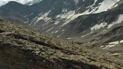 Aerial view of sky-runner running high in the mountains. Stock Footage 140973490