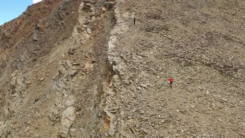 Aerial view of sky-runner running high in the mountains. Video stock 140973675