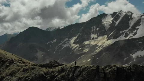 Aerial view of sky-runner running high in the mountains. Stock Footage 140973821