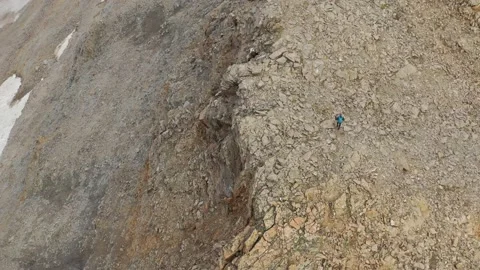 Aerial view of sky-runner running high in the mountains. Stock Footage 140973871