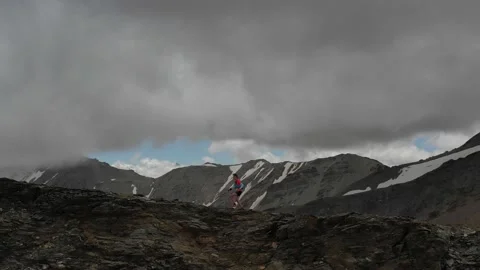 Aerial view of sky-runner running high in the mountains. Stock Footage 140973970