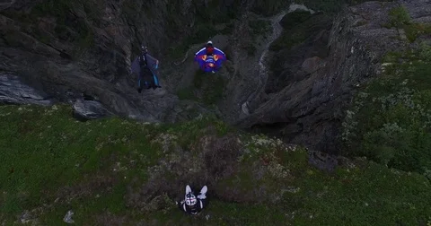 Aerial View of Skydivers Jump Off Cliff Wall Stock Footage 82270575