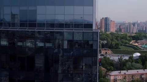 Aerial view of the skyscraper and window cleaners washing the windows Stock Footage 93348932