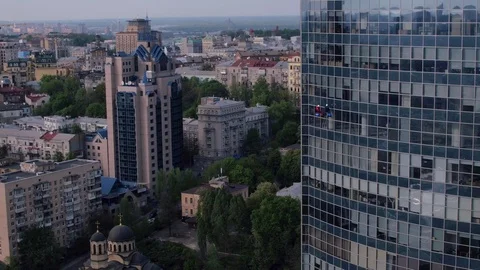 Aerial view of the skyscraper and window cleaners washing the windows Stock Footage 93349310