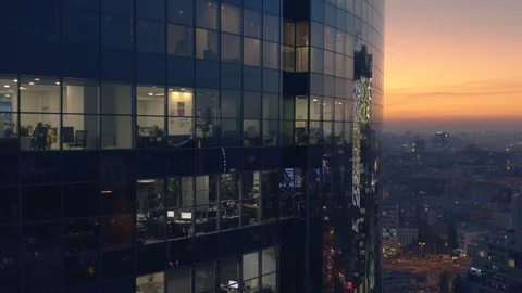 Aerial view of skyscraper office glowing windows at sunset. Down shot Stock Footage 96552153