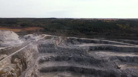 Aerial view of Slope operating granite quarry with mining equipment on ledges Stock Footage 164897623