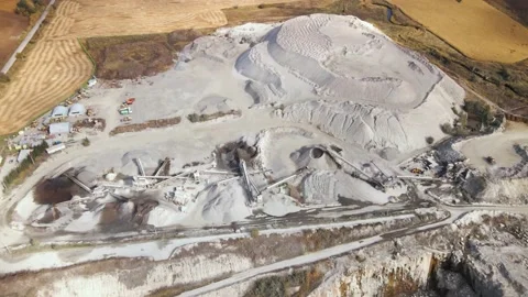 Aerial view of Slope operating granite quarry with mining equipment on ledges Stock Footage 164898152