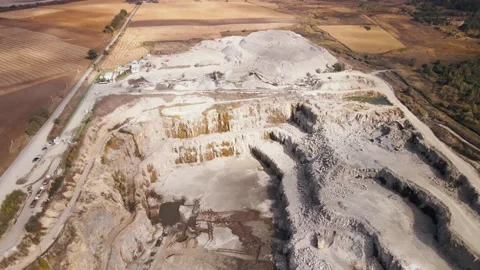 Aerial view of Slope operating granite quarry with mining equipment on ledges Stock Footage 164898419