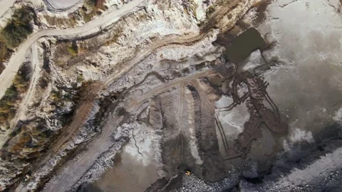 Aerial view of Slope operating granite quarry with mining equipment on ledges Stock Footage 164899134
