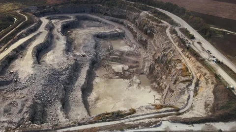 Aerial view of Slope operating granite quarry with mining equipment on ledges Stock Footage 167203076