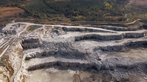 Aerial view of Slope operating granite quarry with mining equipment on ledges Stock Footage 167203407