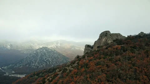 Aerial view of the slopes of the mountain range on the tops of which there are c Stock Footage 151150462