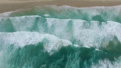 Aerial view - slow descend looking down at large crushing ocean waves Stock Footage 88976733