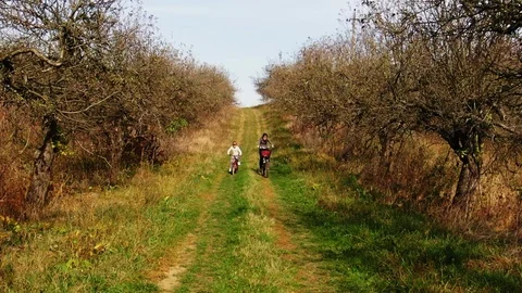 Aerial view slow motion cute girls having ride together in rural landscape 120p Stock Footage 118406427