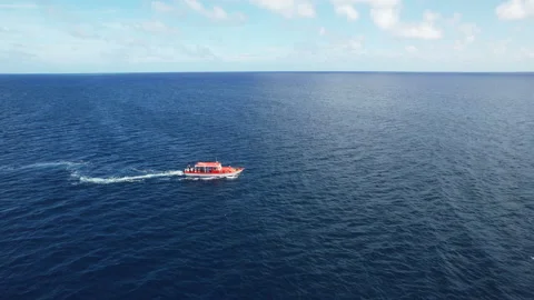 Aerial view slow motion drone shot of luxury motorboat in ocean waters near Stock Footage 256943279