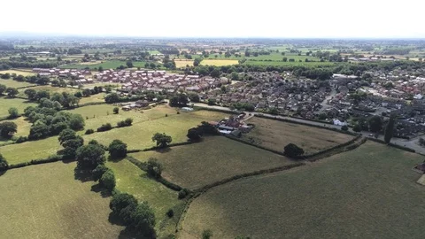 Aerial view, slow panning move. Town in cheshire. Housing development. Plains Stock Footage