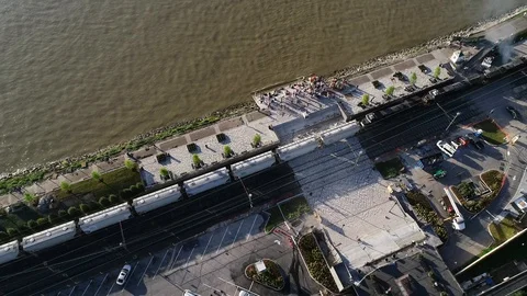 Aerial view of a slow train moving along the banks of the Mississippi River Stock Footage 88890590