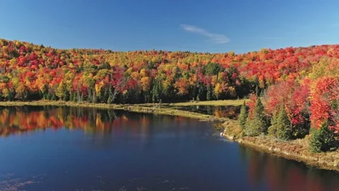 Aerial view, slowly backing up over the lake revealing the mountain Stock Footage 163983074